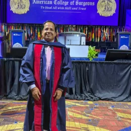 Man in academic regalia at American College of Surgeons event